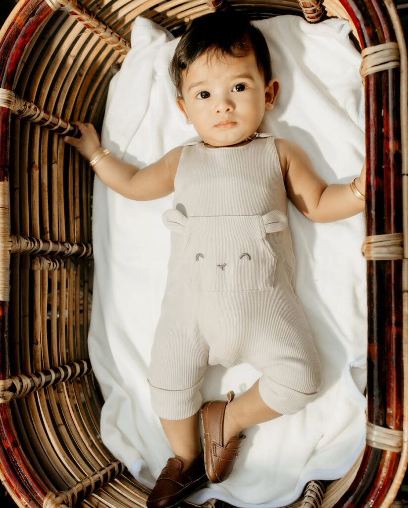 baby boy lying down in basket