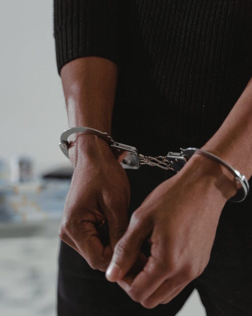 persons hands in handcuffs
